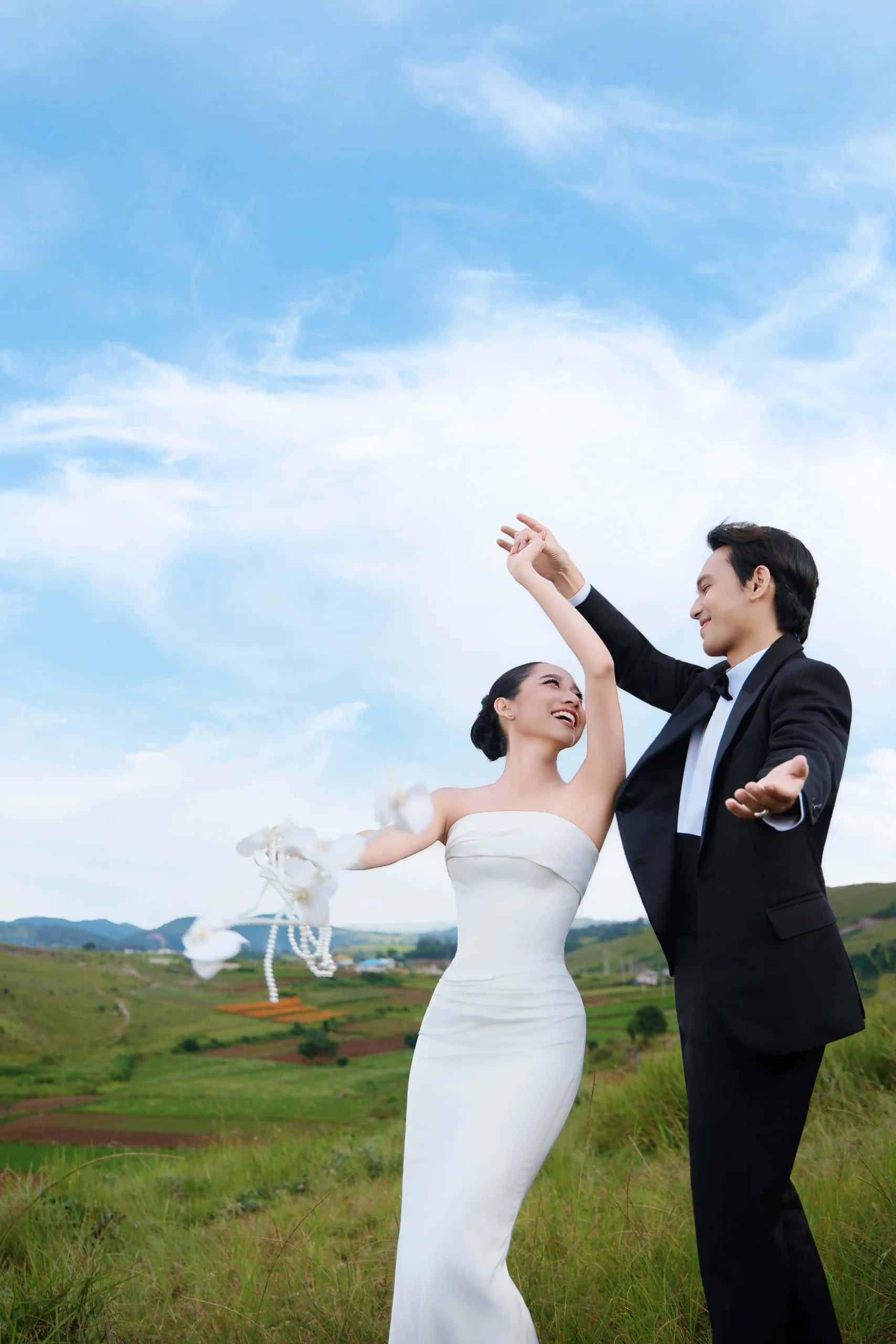 The couple dancing in an open field